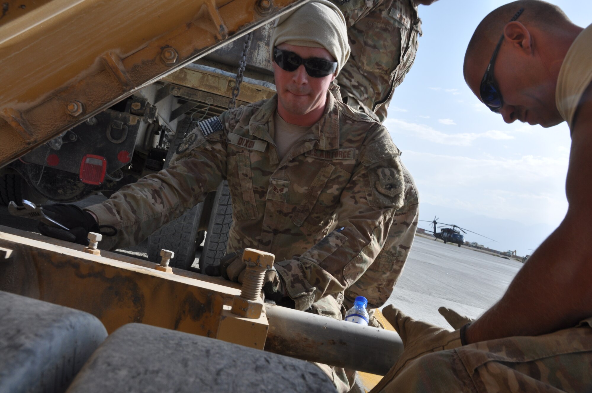 Senior Airman Brandon Dixon, a native of Tyler, Texas, and Staff Sgt. John Chiki, a native of Great Falls, Mont., both from the 557th RED HORSE Squadron, are deployed from Malmstrom Air Force Base, Mont. The two Airmen are working on a perimeter flightline road construction project at Bagram Airfield, Afghanistan, Aug. 19. The project is scheduled to be completed by the end of August. (U.S. Air Force photo/Tech. Sgt. Rob Hazelett)