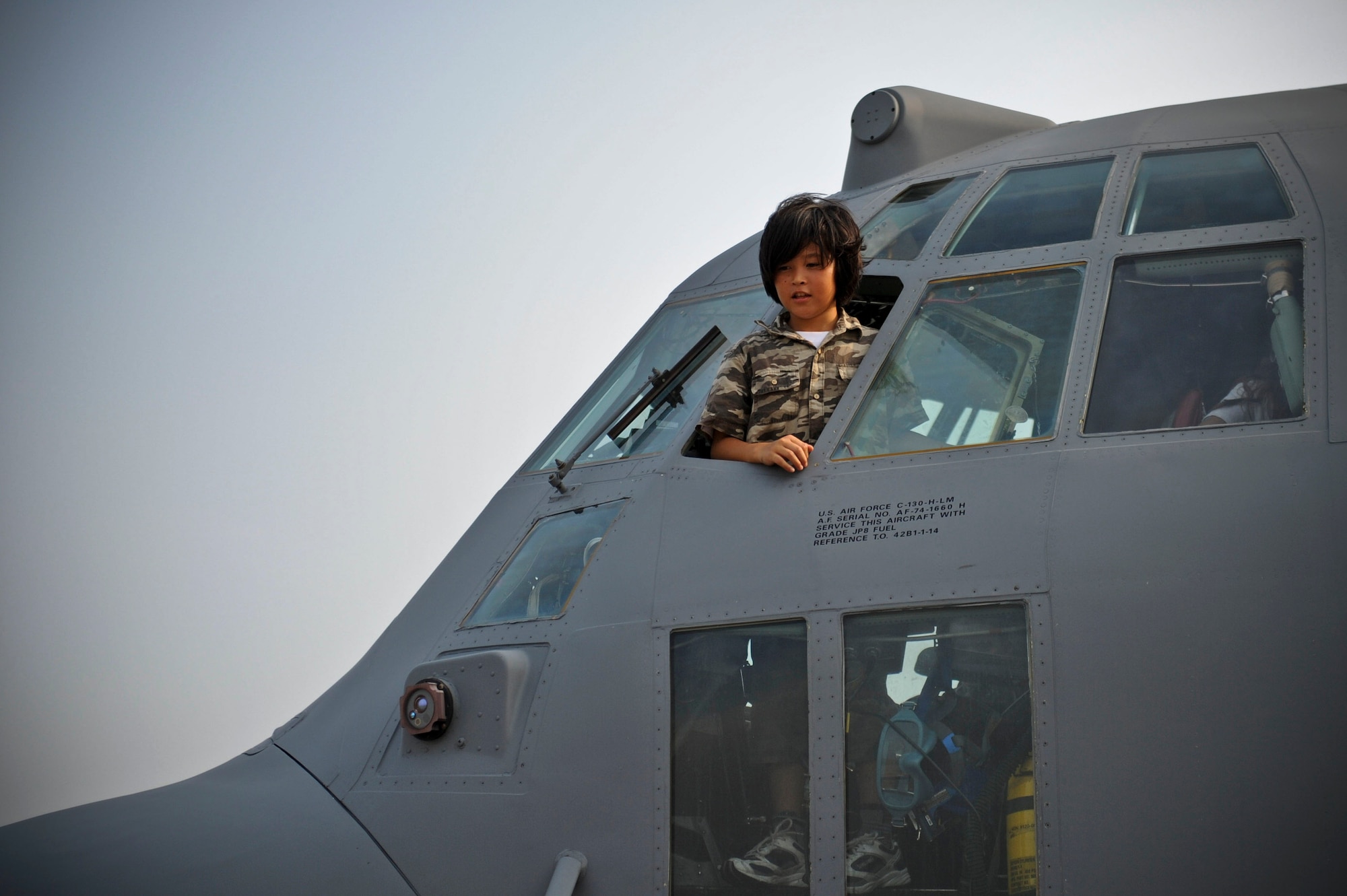 YOKOTA AIR BASE, Japan -- A child from a local school in Tachikawa, Japan, peers out of a C-130 Hercules during the International Exchange Summer Sleepover, Aug. 10, 2013 at Yokota Air Base, Japan.  The children from the sleepover toured the fire station and a C-130 Hercules.  (U.S. Air Force photo by Airman 1st Class Meagan Schutter)