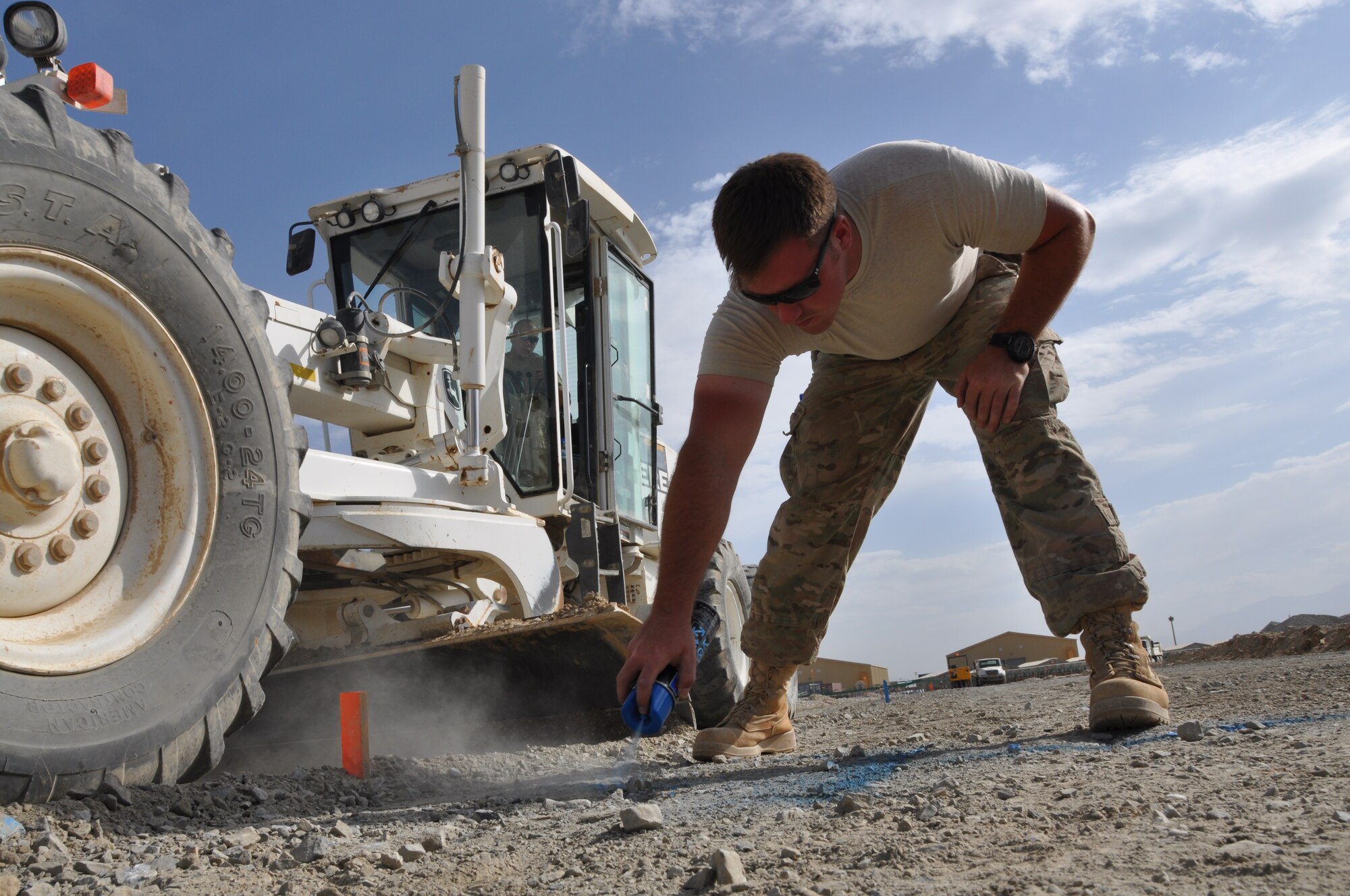 Staff Sgt. Justin Wycoff, 557th RED HORSE Squadron, is deployed from Malmstrom Air Force Base, Mont., and a native of James, Mo., is working on the perimeter flightline road construction project at Bagram Airfield, Afghanistan, Aug. 19. The project is scheduled to be completed by the end of August. (U.S. Air Force photo/Tech. Sgt. Rob Hazelett)
