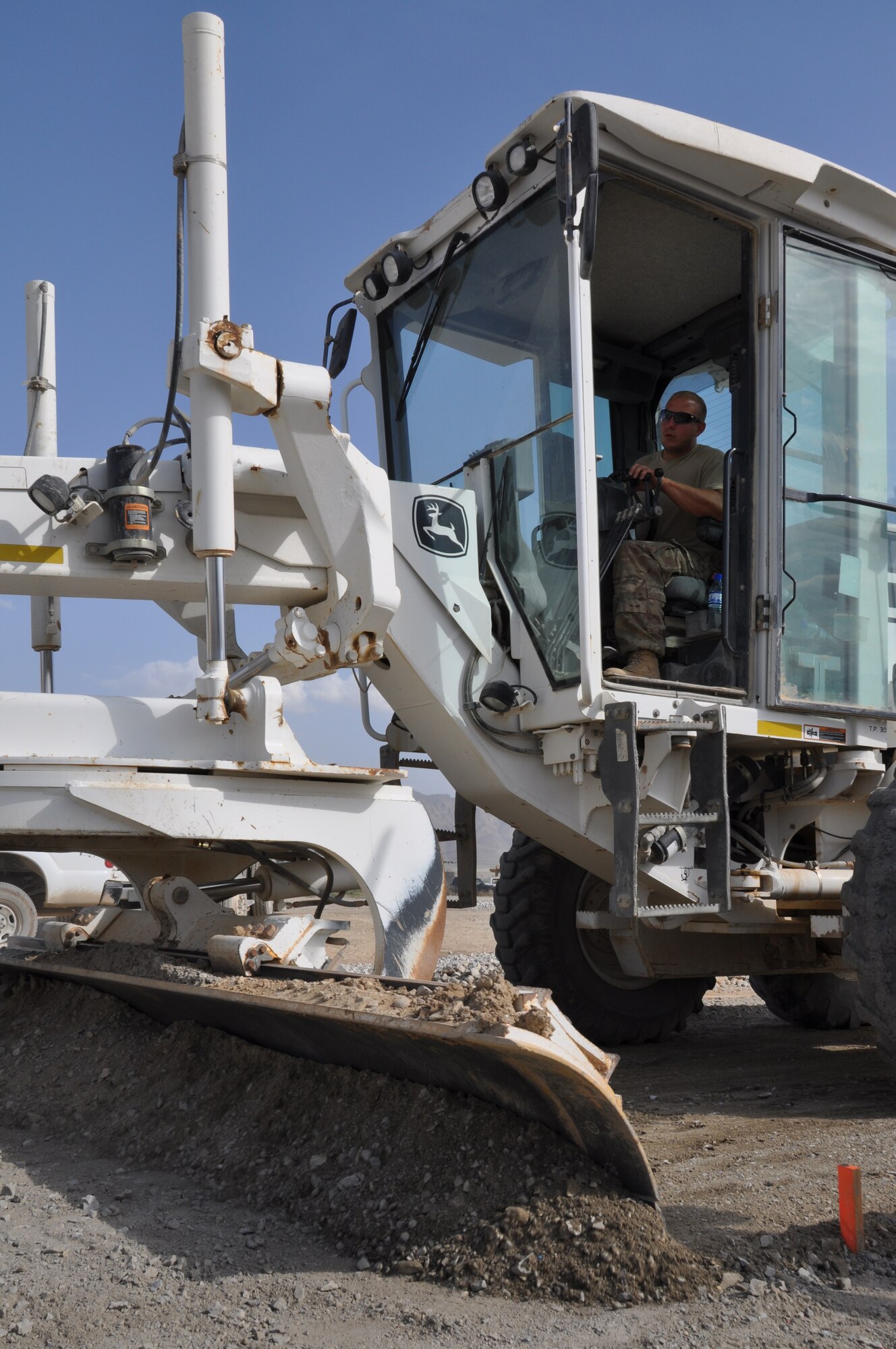 Staff Sgt. Travis Woody, 557th RED HORSE Squadron, is deployed from Malmstrom Air Force Base, Mont., and a native of Roan Mountain, Tenn., is working on the perimeter flightline road construction project at Bagram Airfield, Afghanistan, Aug. 19. The project is scheduled to be completed by the end of August. (U.S. Air Force photo/Tech. Sgt. Rob Hazelett)