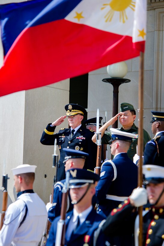 U.S. Army Gen. Martin E. Dempsey, left, chairman of the Joint Chiefs of Staff, and Philippines Chief of Staff Gen. Emmanuel Bautista salute during a ceremony to welcome the Philippine military leader to the Pentagon, Aug. 22, 2013.
