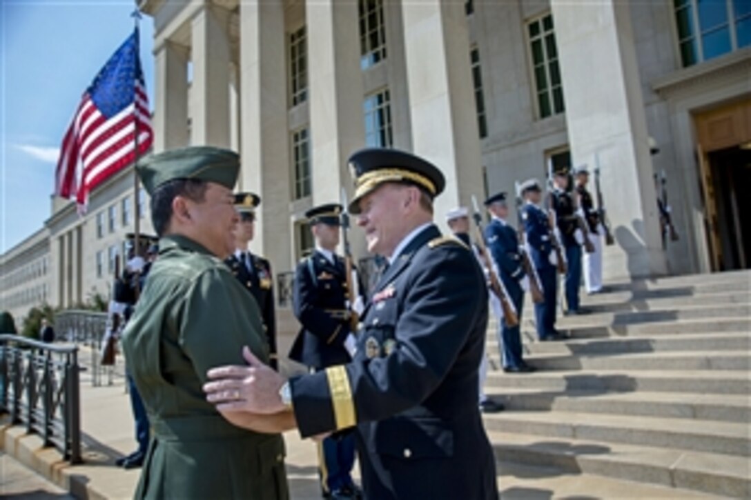 U.S. Army Gen. Martin E. Dempsey, right, chairman of the Joint Chiefs of Staff, greets Philippine Chief of Staff Gen. Emmanuel Bautista at the Pentagon, Aug. 22, 2013. Dempsey hosted a welcome ceremony and the two leaders discussed security issues.