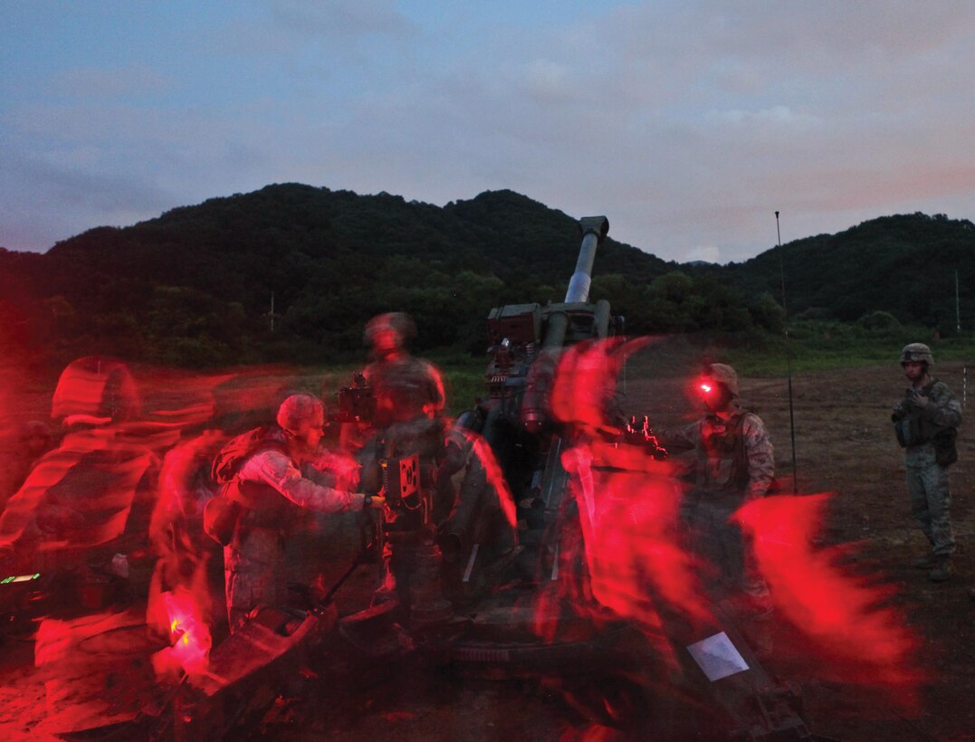 Marines execute preparation fire training at Rodriguez Live-Fire Complex, Republic of Korea Aug. 16 prior to Korean Marine Exchange Program 13-8. The U.S. Marine Corps artillerymen will train with ROK Marines, exchanging standard operating procedures and comparing capabilities. The artillerymen are with India Battery, 3rd Battalion, 11th Marine Regiment, currently assigned to 3rd Bn., 12th Marine Regiment, 3rd Marine Division, III Marine Expeditionary Force, under the unit deployment program. The photographer used a combination of low light and a slow shutter speed to create a ghostlike effect on the faster-moving subjects.