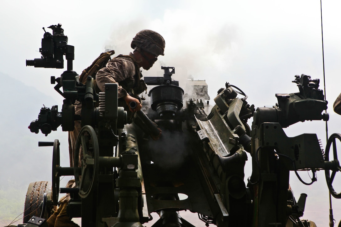 Lance Cpl. Julian J. Saucedo clears an M777A2 155 mm lightweight howitzer at the Rodriguez Live-Fire Complex, Republic of Korea, Aug. 16 in preparation for the Korean Marine Exchange Program 13-8. The artillerymen fired 155 mm high-explosive rounds using five different howitzers. The U.S. artillerymen fired the weapons alongside ROK Marines, while exchanging standard operating procedures and comparing capabilities. Saucedo is an artilleryman with India Battery, 3rd Battalion, 11th Marine Regiment, currently assigned to 12th Marine Regiment, 3rd Marine Division, III Marine Expeditionary Force, under the unit deployment program. 