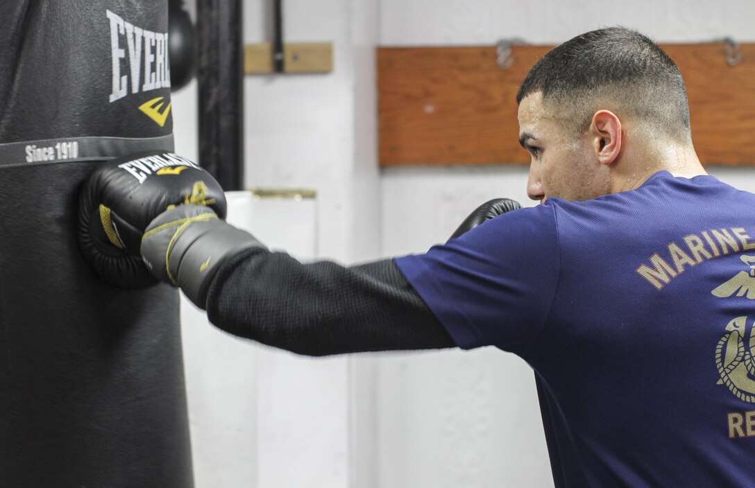 NEW YORK - Staff Sgt. Todd Dekinderen, a recruiter at Marine Corps Recruiting Substation Brooklyn, Recruiting Station New York, hits the heavy bag at the Sadam Ali Boxing Center in Brooklyn, Feb. 28.  Dekinderen is training with hopes of picking up where he left off and aspires to become a professional boxer.  (U.S. Marine Corps photo by Sgt. Kristin E. Moreno).