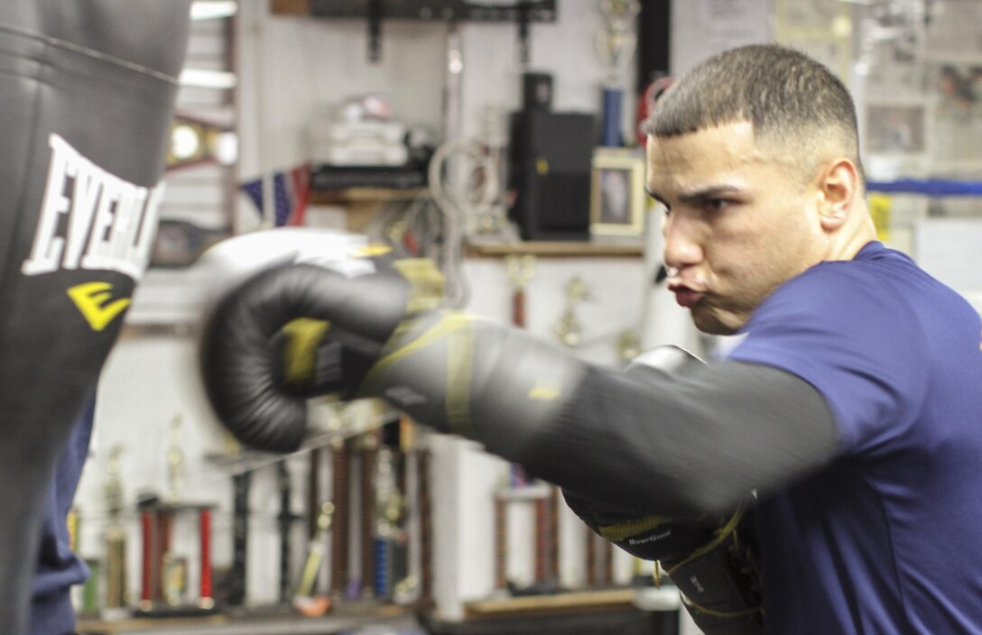 NEW YORK - Staff Sgt. Todd Dekinderen, a recruiter at Marine Corps Recruiting Substation Brooklyn, Recruiting Station New York, hits the heavy bag at the Sadam Ali Boxing Center in Brooklyn, Feb. 28.  Dekinderen aspires to become a professional boxer and credits the Marine Corps for his success in the sport.  (U.S. Marine Corps photo by Sgt. Kristin E. Moreno).