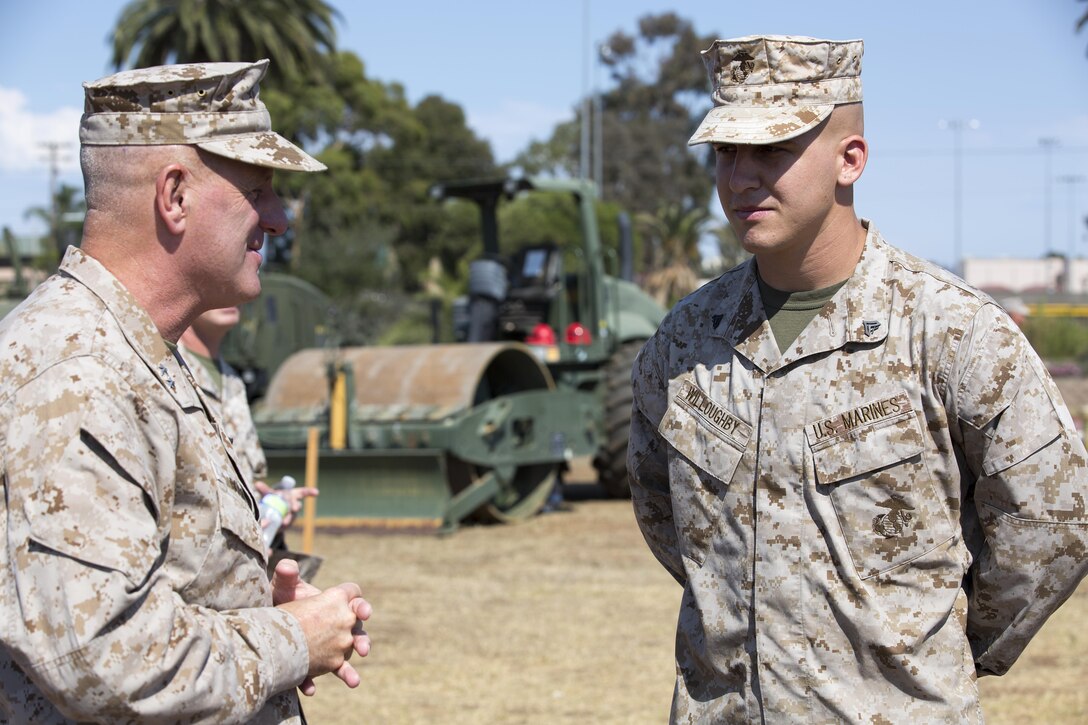 Maj. Gen. Steven W. Busby, 3rd Marine Aircraft Wing commanding general, explains to Cpl. Mark Willoughby Jr., an air command and control electronics operator with Marine Tactical Air Command Squadron 38 and an Artesia, Calif. native that he will be the first to run the first obstacle course aboard Marine Corps Air Station Miramar, Calif. Aug. 22. Willoughby estimates he will be able to run the course in under two-and-a-half minutes when the last post stands up in November.