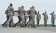 A carry team transfers the remains of a fallen Airman during a dignified transfer, April 30, 2013, at Dover Air Force Base, Del. A solemn dignified transfer of remains is conducted upon arrival at Dover AFB from the aircraft to a transfer vehicle to honor those who have given their lives in service to America.