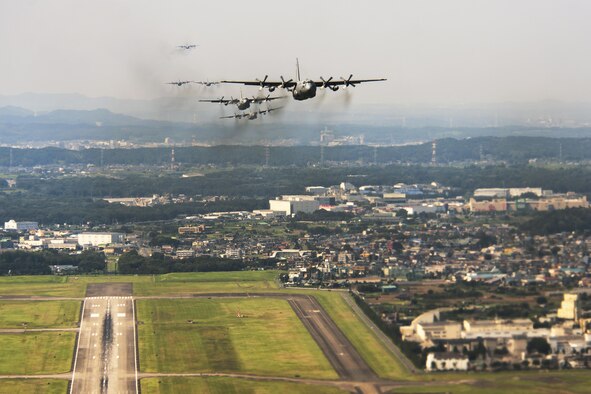 C-130 Hercules aircraft fly during a training mission above Yokota Air Base, Japan, Aug. 19, 2013. Seven C-130s flew in formation to practice airlift tactics and procedures. (U.S. Air Force photo/Osakabe Yasuo)