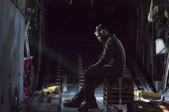 Airman 1st Class Wynthom Thomas communicates with pilots after landing at Yokota Air Base, Japan, Aug. 19, 2013. Seven C-130 Hercules aircraft flew in formation to practice airlift tactics and procedures. Thomas is a 36th Airlift Squadron loadmaster. (U.S. Air Force photo/Osakabe Yasuo)