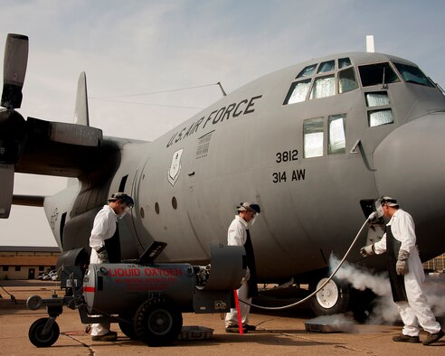 Tech. Sgt. Bryan Lonowski trains Airman Basic Thomas O’Connor and Airman 1st Class Trenton Wyant on how to transfer liquid oxygen to an oxygen reservoir in a C-130 Hercules during the crew chief course, Aug. 14, 2013, at Sheppard Air Force Base, Texas. Students learn the required maintenance requirements step by step in the training manual. Lonowski is assigned to the 362nd Training Squadron. (U.S. Air Force photo/Danny Webb)
