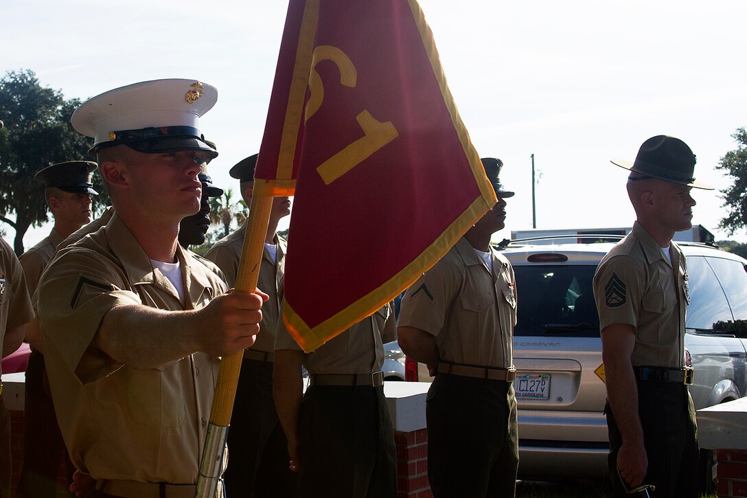 Pfc. Seth Killingsworth, honor graduate for platoon 1061, stands at parade rest with Staff Sgt. Joshua Riddle, Senior Drill Instructor of platoon 1061, before graduation aboard Parris Island, S.C., Aug. 23, 2013. Killingsworth, a native of Stantonville, Tenn., was recruited by Sgt. Justin Martinez, recruiter from Recruiting Substation Jackson, Recruiting Station Nashville. Killingsworth will be able to enjoy some much deserved leave with his family after graduation. (U.S. Marine Corps photo by Lance Cpl. John-Paul Imbody)