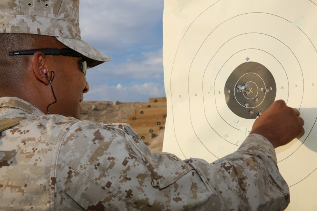 Gunnery Sgt. Joel Berberena , the property chief on Marine Corps Logistics Base Barstow, examines his target after firing  the M9 during the pistol pre-qualification  at the base’s rifle and pistol range, Aug. 22. The base offers more than 2,400 acres to units in the southwest region. It also houses a 1,000-yard rifle range as well as a pistol and shotgun range.  The ranges provide sustainment and qualification training for service members and provide a unique environment for local law enforcement agencies to 
