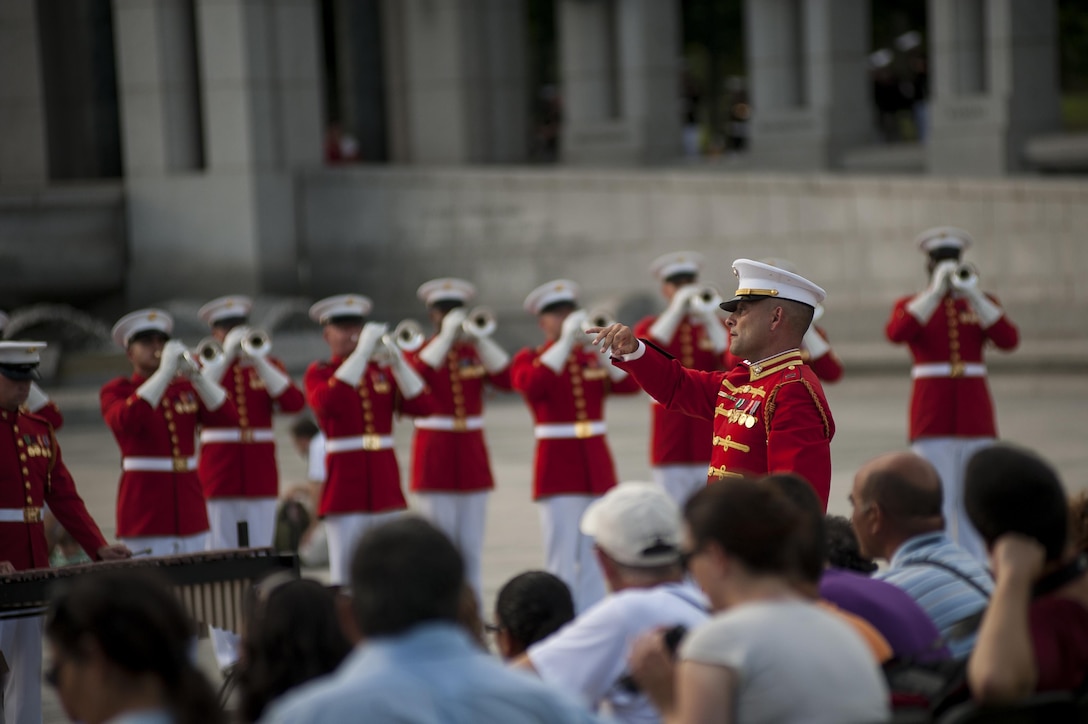 Capt. Christopher Hall, executive officer of the U.S. Marine Drum & Bugle Corps, directs the the D & B during a World War II Memorial Concert in Washington, D.C., Aug. 21.  The D & B and the U.S. Marine Corps Silent Drill Platoon performed in honor of U.S. servicemembers who died during World War II. (Official Marine Corps photo by Lance Cpl. Dan Hosack/Released)