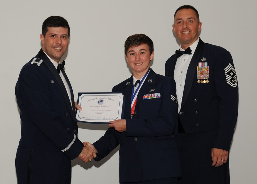 Senior Airman Jennifer Biscardi, 2nd Operation Support Squadron, receives an Airman Leadership School graduation certificate from Col. Andrew Gebara, 2nd Bomb Wing commander, on Barksdale Air Force Base, La., June 21, 2013. (U.S. Air Force photo).