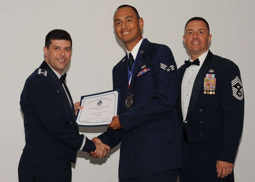 Senior Airman Jonathan Villa Vargas, 452nd Logistics Readiness Squadron, receives an Airman Leadership School graduation certificate from Col. Andrew Gebara, 2nd Bomb Wing commander, on Barksdale Air Force Base, La., June 21, 2013. (U.S. Air Force photo).