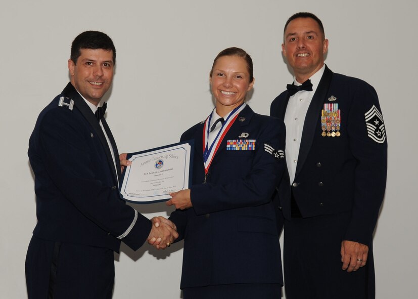 Senior Airman Leah Lombardozzi, 608th Air Operations Center, receives an Airman Leadership School graduation certificate from Col. Andrew Gebara, 2nd Bomb Wing commander, on Barksdale Air Force Base, La., June 21, 2013. (U.S. Air Force photo).