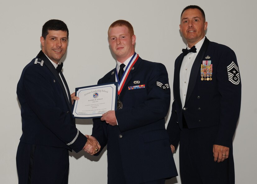 Senior Airman Billy Gilmore, 2nd Maintenance Squadron, receives an Airman Leadership School graduation certificate from Col. Andrew Gebara, 2nd Bomb Wing commander, on Barksdale Air Force Base, La., June 21, 2013. (U.S. Air Force photo).