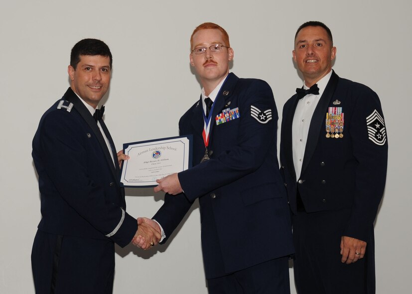 SSgt Bryan Gillam, 2nd Munitions Squadron, receives an Airman Leadership School graduation certificate from Col. Andrew Gebara, 2nd Bomb Wing commander, on Barksdale Air Force Base, La., June 21, 2013. (U.S. Air Force photo).