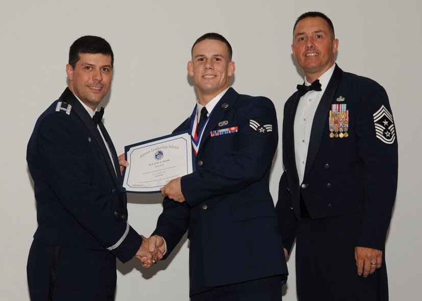 Senior Airman Erik Sands, 2nd Maintenance Squadron, receives an Airman Leadership School graduation certificate from Col. Andrew Gebara, 2nd Bomb Wing commander, on Barksdale Air Force Base, La., June 21, 2013. (U.S. Air Force photo).