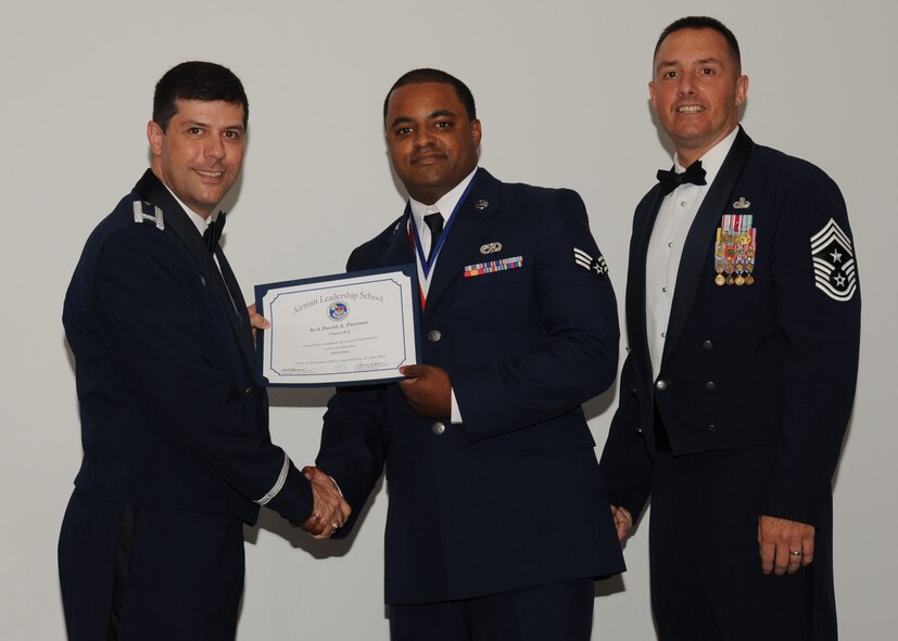 Senior Airman David Pearson, 2nd Aircraft Maintenance Squadron, receives an Airman Leadership School graduation certificate from Col. Andrew Gebara, 2nd Bomb Wing commander, on Barksdale Air Force Base, La., June 21, 2013. (U.S. Air Force photo).