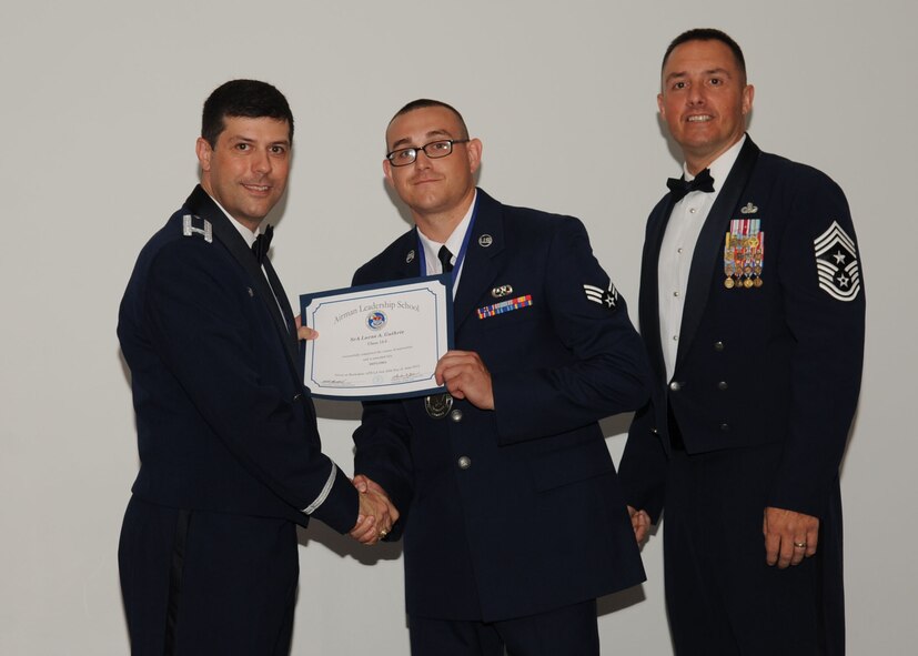 Senior Airman Lucas Guthrie, 2nd Aircraft Maintenance Squadron, receives an Airman Leadership School graduation certificate from Col. Andrew Gebara, 2nd Bomb Wing commander, on Barksdale Air Force Base, La., June 21, 2013. (U.S. Air Force photo).