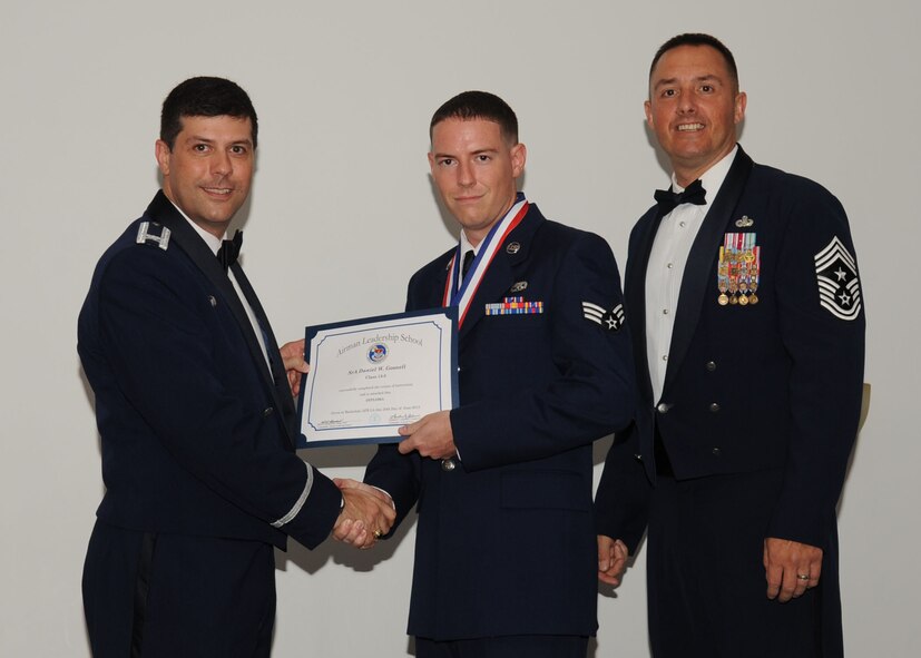 Senior Airman Daniel Gosnell, 2nd Aircraft Maintenance Squadron, receives an Airman Leadership School graduation certificate from Col. Andrew Gebara, 2nd Bomb Wing commander, on Barksdale Air Force Base, La., June 21, 2013. (U.S. Air Force photo).
