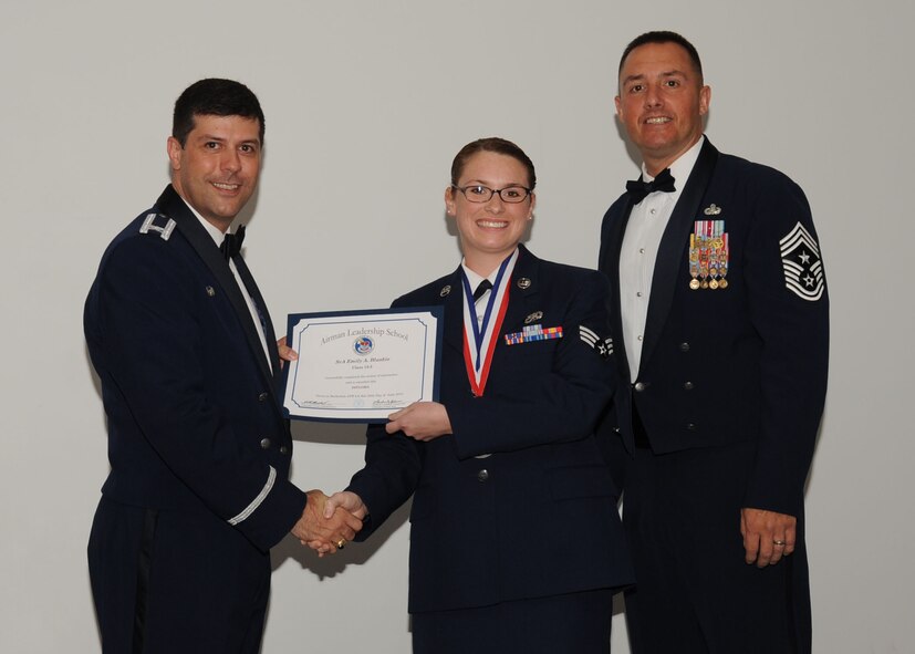 Senior Airman Emily Blaskie, 2nd Aircraft Maintenance Squadron, receives an Airman Leadership School graduation certificate from Col. Andrew Gebara, 2nd Bomb Wing commander, on Barksdale Air Force Base, La., June 21, 2013. (U.S. Air Force photo).