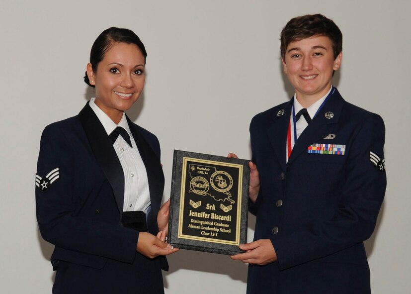 Senior Airman Jennifer Biscardi, 2nd Operation Support Squadron, receives the Distinguished Graduate Award from Senior Airman Karina Reyes, 2nd Contracting Squadron, on behalf of the Air Force Sergeants Association during the Airman Leadership School Class 13-5 Graduation on Barksdale Air Force Base, La., June 21, 2013. (U.S. Air Force photo)