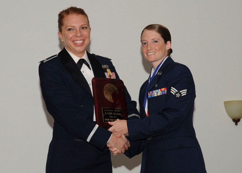 Senior Airman Holly Stevenson, 26th Operational Weather Squadron, receives the Academic Award Plaque from 1st Lt. Carissa Hoosline, 2nd Force Support Squadron, during the Airman Leadership School Class 13-5 Graduation on Barksdale Air Force Base, La., June 21, 2013. (U.S. Air Force photo)