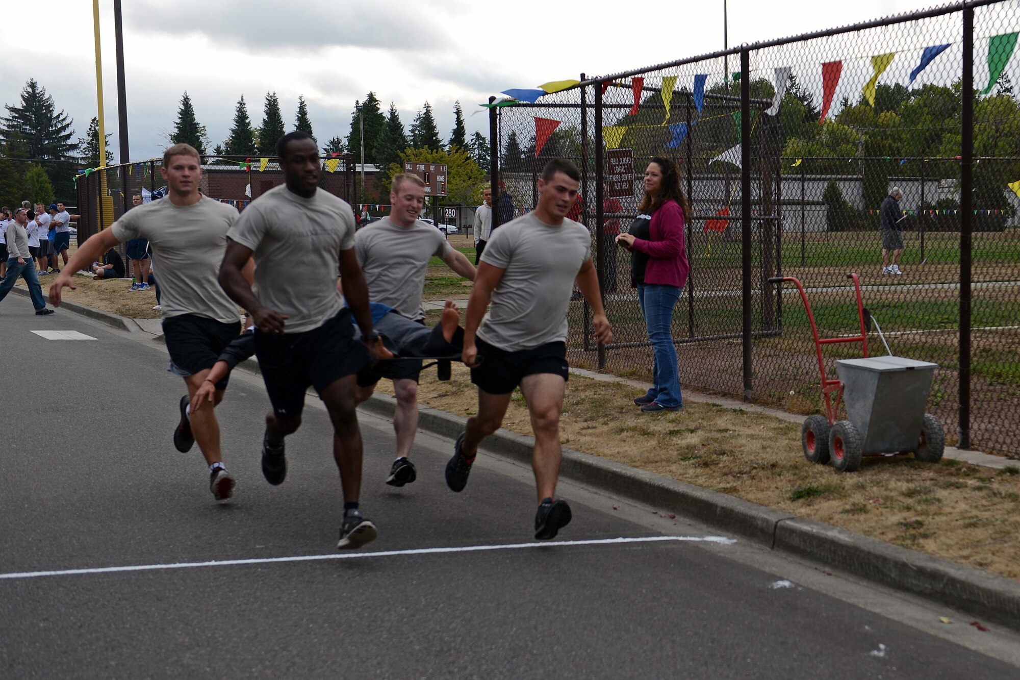 Airmen from the 5th Air Support Operations Squadron run a relay race carrying a stretcher Aug. 23, 2013 during Team McChord’s Sports Day at Joint Base Lewis-McChord, Wash. Airmen from across JBLM participated in a variety of different games and challenges of the day promoting fitness and fun. (U.S. Air Force photo/Airman 1st Class Jacob Jimenez)