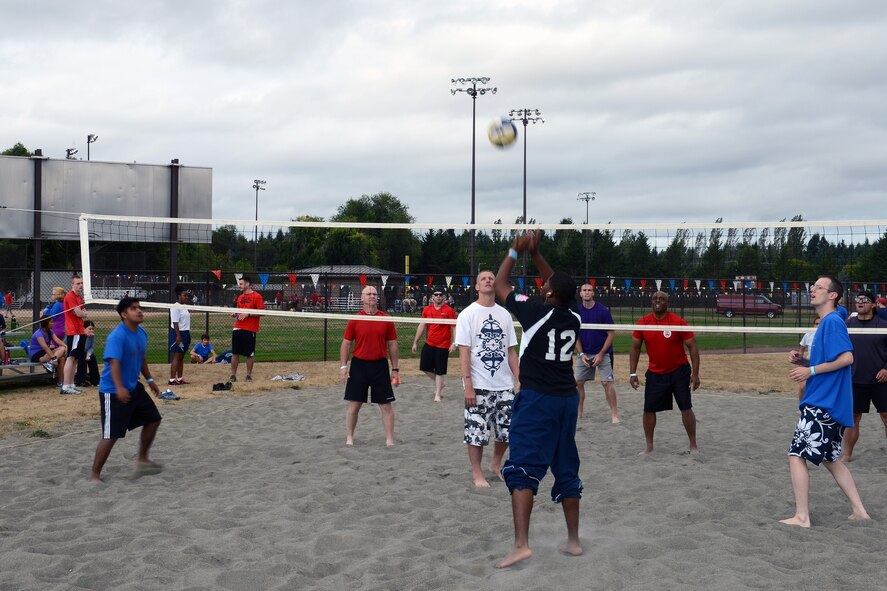 Airman 1st Class Andrew Wanzo, 62nd Comptrollers Squadron, sets a ball during a beach volleyball game during Team McChord’s Sports Day Aug. 23, 2013 at Joint Base Lewis-McChord, Wash. Team’s participating in the day’s games were judged on team spirit, winning scores and team diversity. (U.S. Air Force photo/Airman 1st Class Jacob Jimenez) 