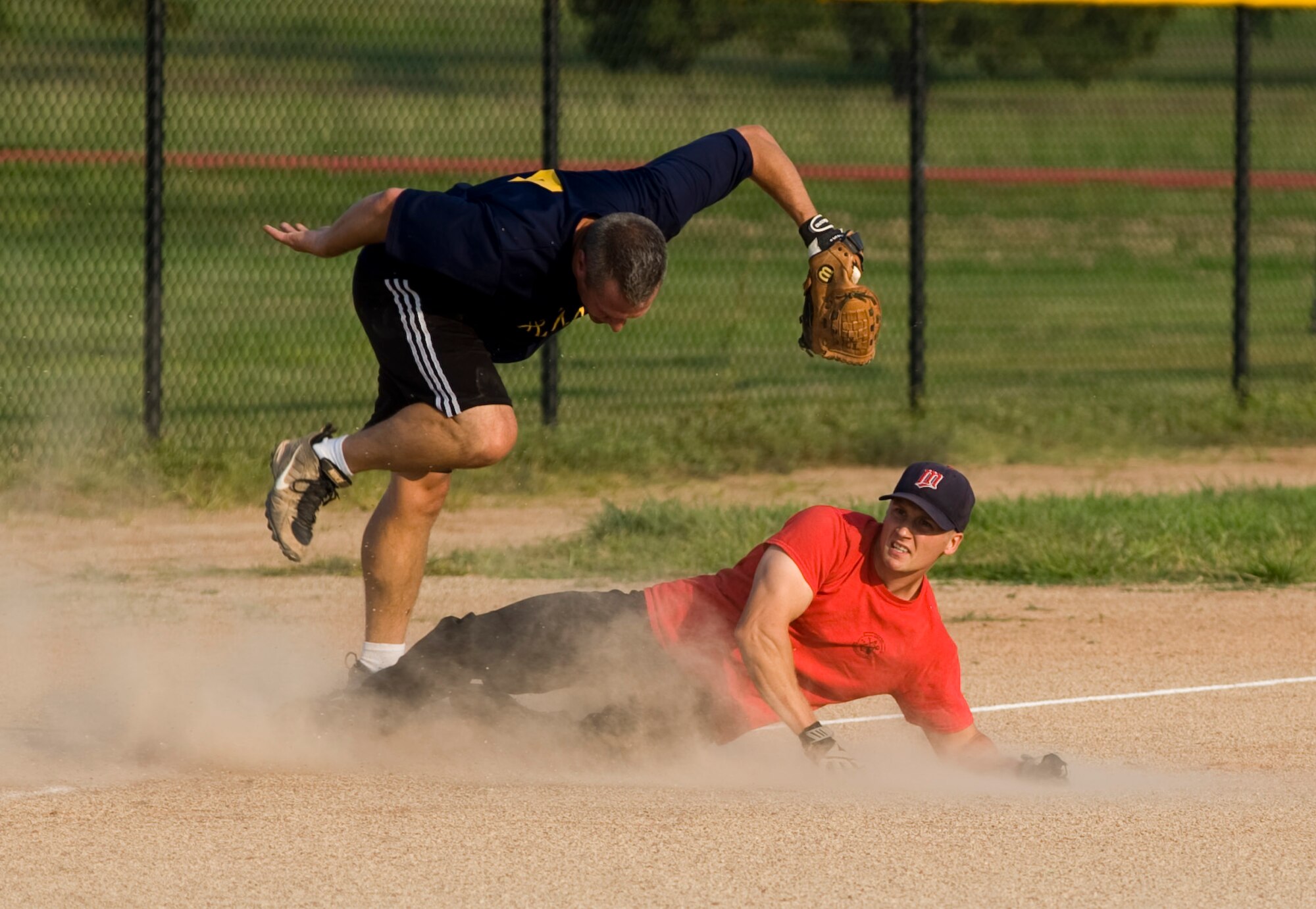 Senior Airman Casey Johnson, 22nd Maintenance Squadron aerospace propulsion journeyman, slides to 3rd base during the base intramural softball championship Aug. 21, 2013, at McConnell Air Force Base Kan. Both squadrons work very closely together to support the Air Force mission. (U.S. Air Force photo/Airman 1st Class John Linzmeier)