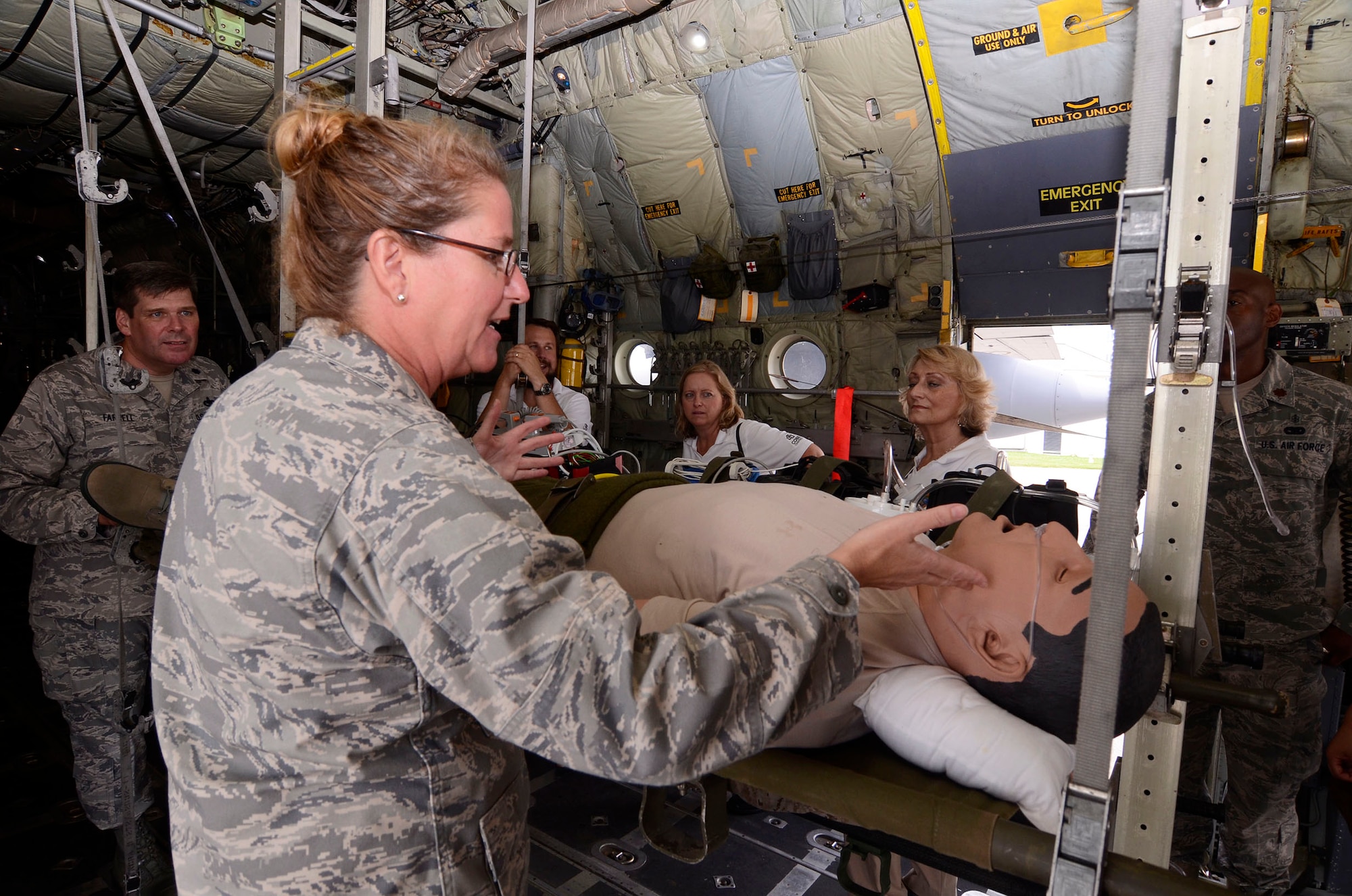 Maj. Karen L. Knoblock from the 94th Aeromedical Evacuation Squadron briefs Local Honorary Commanders Association members on the roles of medical flight crews on medical air evacuation missions during a tour of Dobbins Air Reserve Base, Ga. Aug 21.  Dobbins Day program HCA attendees  experienced additional base sites including a realistic aircraft fire demonstration, Eastern Regional C-130 Hercules Flight Simulator, Force Support Combat Training Center, base operations, weather station and air traffic control tower, as well as static displays by an Explosive Ordnance Disposal team. (U.S. Air Force photo/Don Peek)