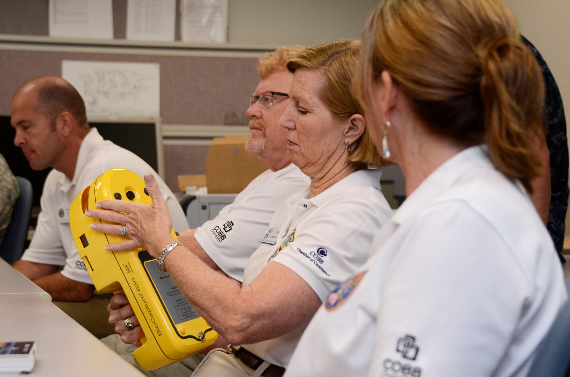 Local Honorary Commanders Association members receives a demonstration of chemical defense equipment during a tour of Dobbins Air Reserve Base, Ga. Aug 21.  Dobbins Day program HCA attendees  experienced additional base sites including a realistic aircraft fire demonstration, Eastern Regional C-130 Hercules Flight Simulator, Force Support Combat Training Center, base operations, weather station and air traffic control tower, as well as static displays by an Explosive Ordnance Disposal team, C-130 Hercules air crews and briefings from 94th Aeromedical Evacuation Squadron personnel. (U.S. Air Force photo/Don Peek)