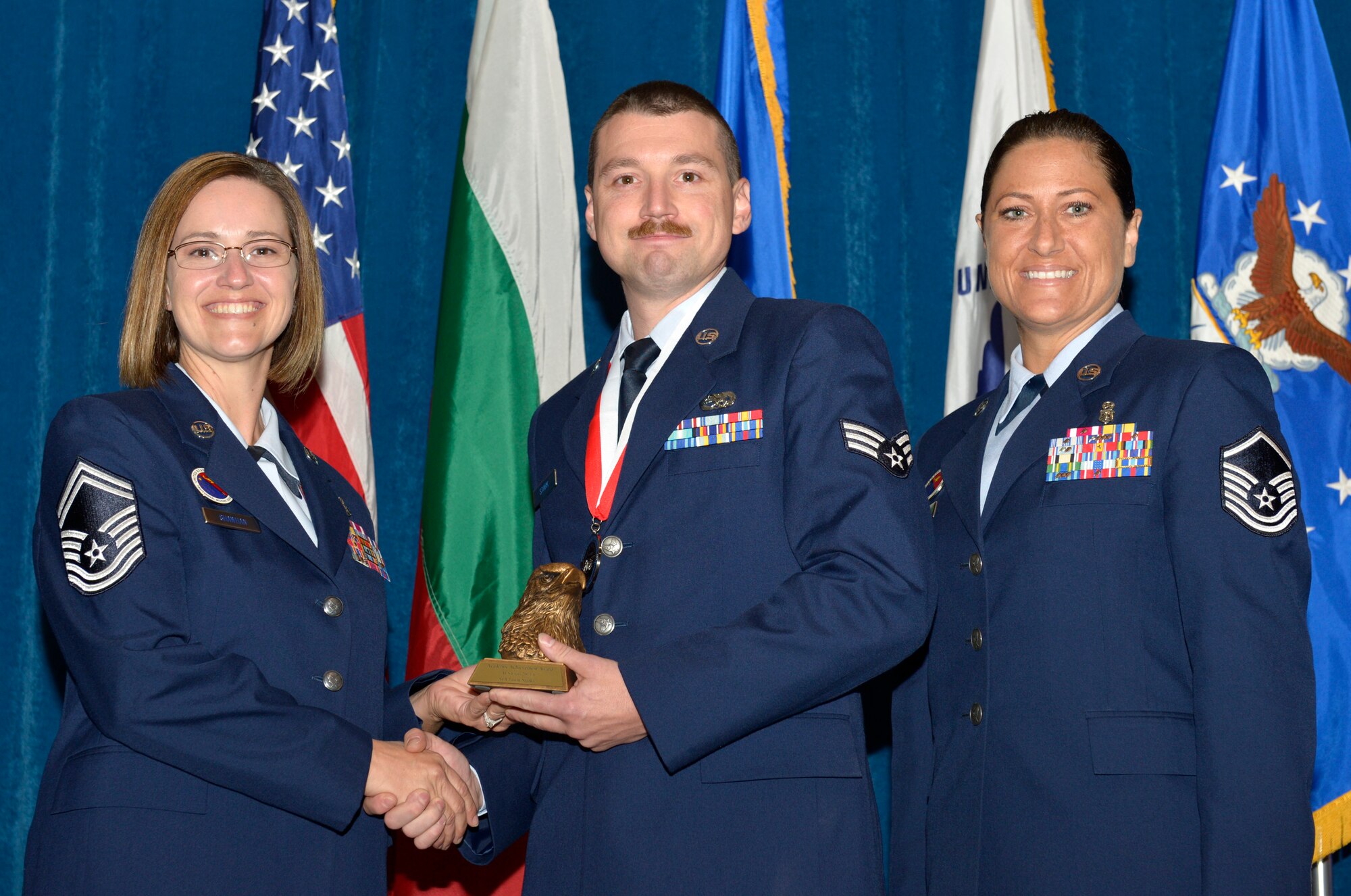 McGHEE TYSON AIR NATIONAL GUARD BASE, Tenn. - Senior Airman Jason G. Stark, right, from New York ANG, receives the academic achievement award for Airman Leadership School Class 13-6 at the I.G. Brown Training and Education Center here  from Senior Master Sgt. Paula C. Shawhan, EPME Director of Education, and Master Sgt. Veronica Ross, former Director of Education, Aug. 15, 2013. The academic achievement award denotes excellence as a scholar. It is based upon all summative objective tests and individual performance evaluations and is given to the student with the highest overall academic standing. (U.S. Air National Guard photo by Master Sgt. Kurt Skoglund/Released)