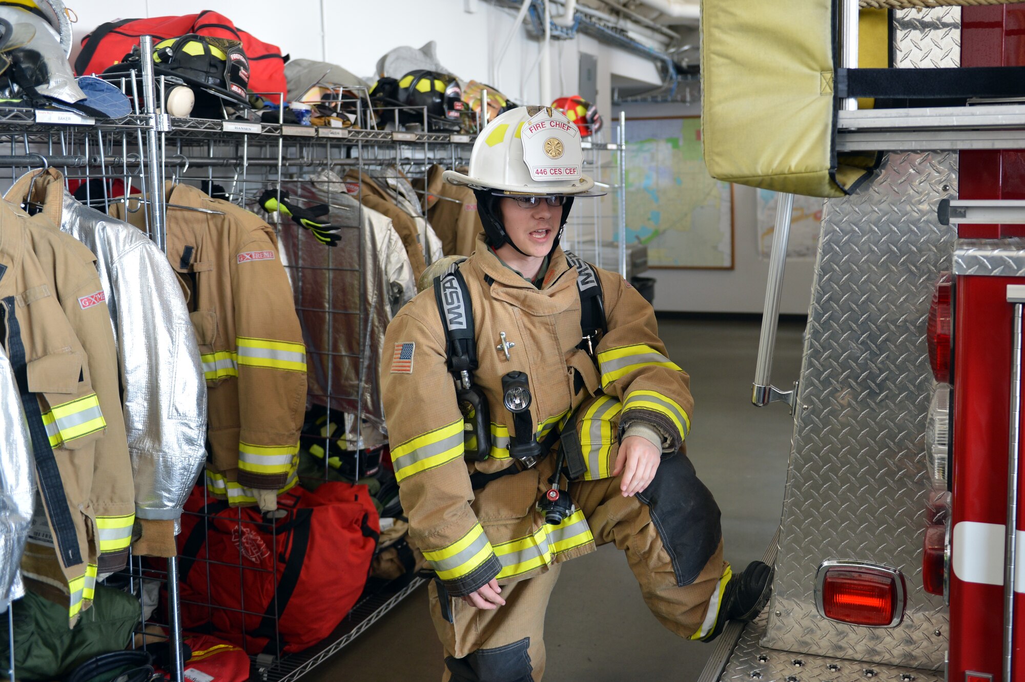 Wearing a full firefighter ensemble, Christian Ball, Pilot for a Day recipient, poses for a photo Aug. 22, 2013 at Joint Base Lewis-McChord, Wash. Christian was made the honorary fire chief for the day and received a tour of the fire department. (U.S. Air Force photo/Staff Sgt. Jason Truskowski)