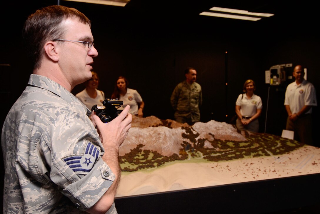 Staff Sgt. Sean R. McDermott, aircrew life support specialist from the 700th Airlift Squadron demonstrates the use of night vision goggle equipment for Local Honorary Commanders Association members while touring Dobbins Air Reserve Base, Ga. Aug 21.  Dobbins Day program HCA attendees  experienced additional base sites including a realistic aircraft fire demonstration, Force Support Combat Training Center, base operations, weather station and air traffic control tower, as well as static displays by an Explosive Ordnance Disposal team, C-130 Hercules air crews and briefings from 94th Aeromedical Evacuation Squadron personnel. (U.S. Air Force photo/Don Peek)