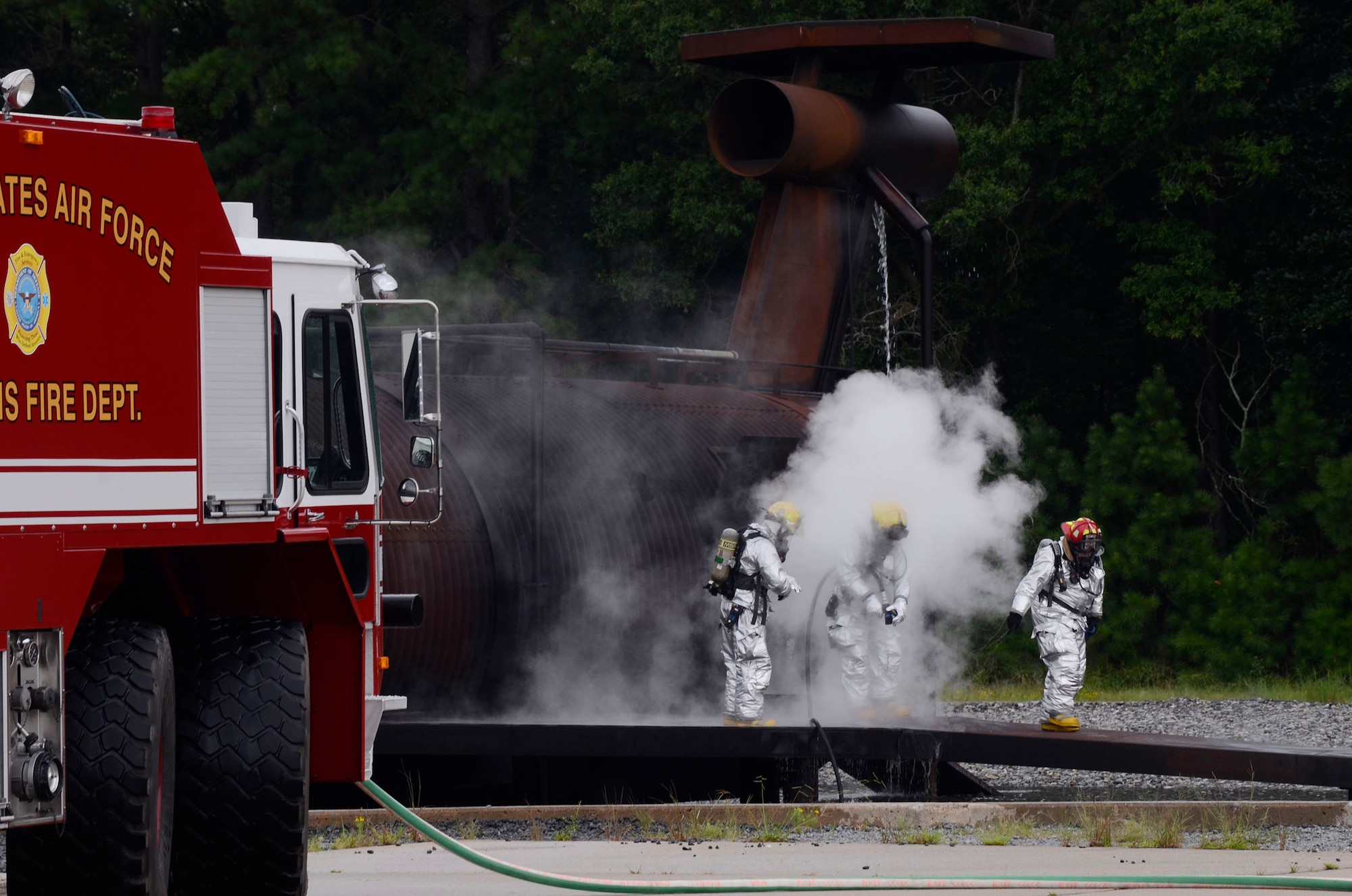 The Dobbins Fire Department crash response team performs a simulated aircraft fire demonstration for local Honorary Commanders Association members touring Dobbins Air Reserve Base, Ga., Aug. 21.  Dobbins Day program HCA attendees  experienced additional base sites including the Eastern Regional C-130 Simulator, Force Support Combat Training Center, base operations, weather station and air traffic control tower, as well as static displays by Explosive Ordnance Disposal team, C-130 Hercules air crews and briefings from 94th Aeromedical Evacuation Squadron personnel. (U.S. Air Force photo/Don Peek)
