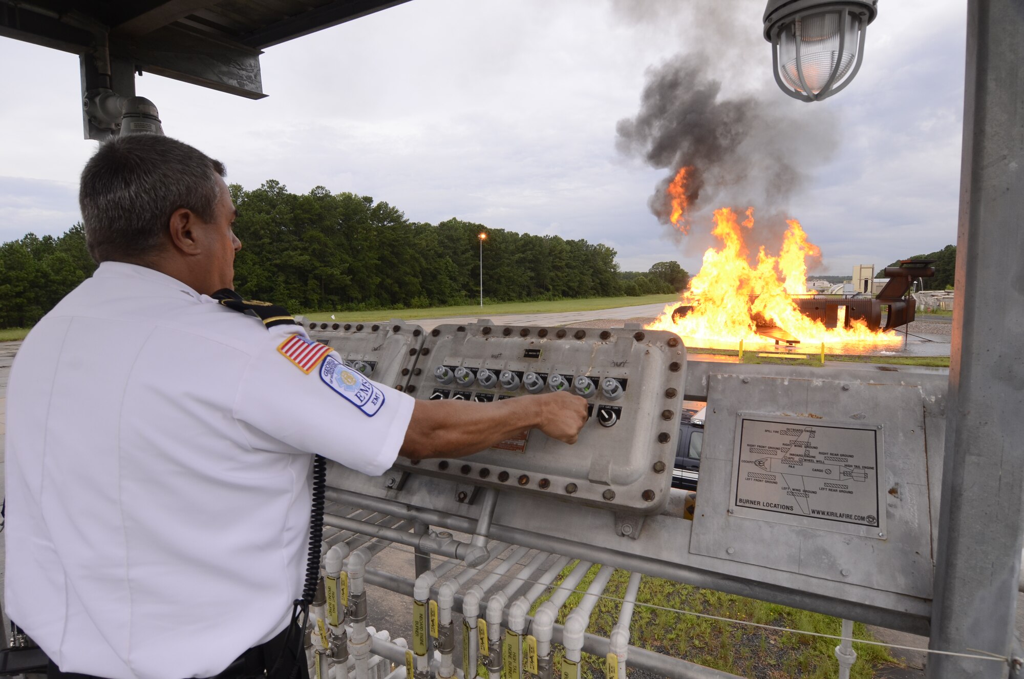 James J. Kula, from the Dobbins Fire Department tests the aircraft burn simulator prior to a fire team response exercise demonstration for local Honorary Commanders Association members touring Dobbins Air Reserve Base, Ga., Aug. 21.  Dobbins Day program HCA attendees  experienced additional base sites including the Eastern Regional C-130 Simulator, Force Support Combat Training Center, base operations, weather station and air traffic control tower, as well as static displays by Explosive Ordnance Disposal team, C-130 Hercules air crews and briefings from 94th Aeromedical Evacuation Squadron personnel. (U.S. Air Force photo/Don Peek)