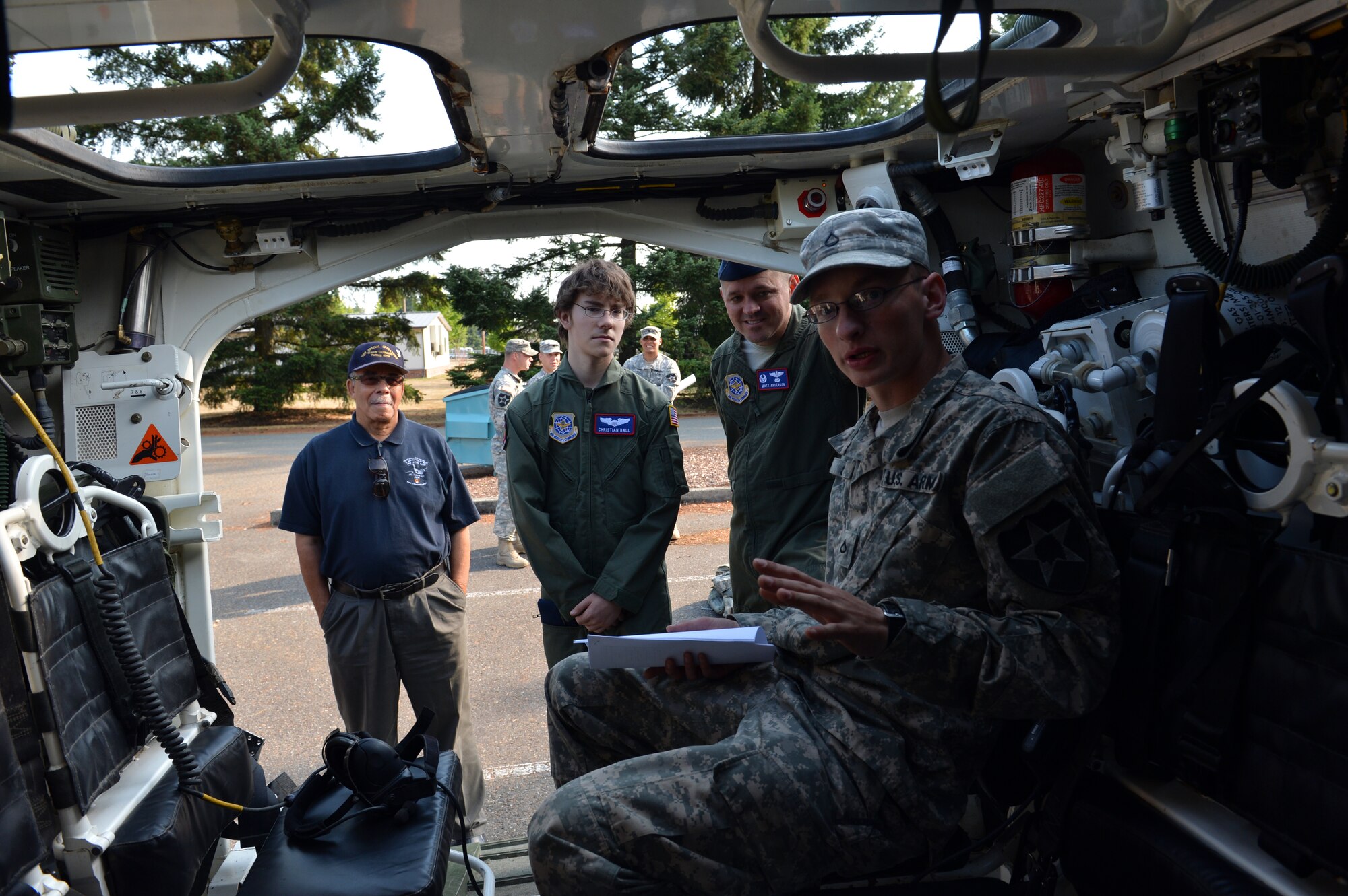 Christian Ball and Lt. Col. Matt Anderson, 4th Airlift Squadron commander, look inside a Stryker during Christian’s Pilot for a Day visit Aug. 22, 2013 at Joint Base Lewis-McChord, Wash. This is the first time soldiers have paired up with Airmen for the Pilot for a Day program at Joint Base Lewis-McChord. (U.S. Air Force photo/Staff Sgt. Jason Truskowski) 