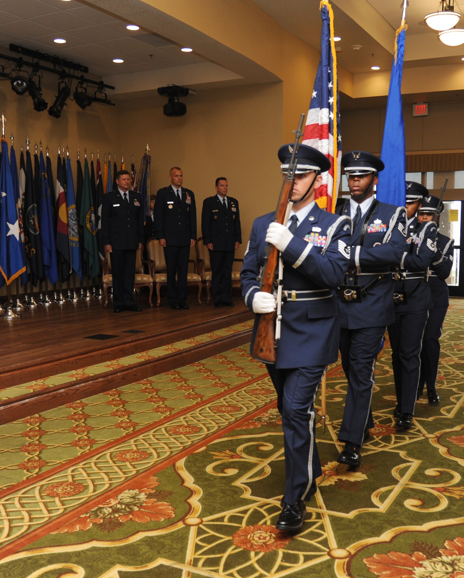 Maj. Gen. Leonard Patrick, 2nd Air Force commander; Brig. Gen. Brad Spacy, outgoing 81st Training Wing commander, and Brig. Gen. Patrick Higby, incoming 81st TRW commander, stand at attention as the Keesler Honor Guard prepares to post the colors during the 81st TRW change of command ceremony Aug. 23, 2013, at the Bay Breeze Event Center, Keesler Air Force Base, Miss.  Spacy has been selected for a new assignment as director for logistics, installations and mission support at Headquarters United States Air Forces in Europe, Ramstein Air Base, Germany.  (U.S. Air Force photo by Kemberly Groue)