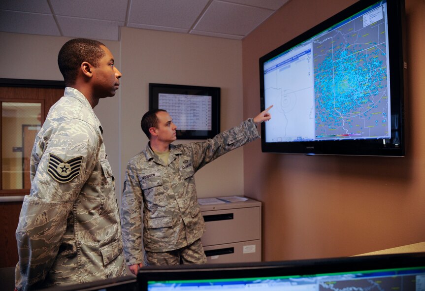 Tech. Sgts. Eric Andrews, left, and Larry Woodson, 2nd Operations Support Squadron weather technicians, observe weather conditions on Barksdale Air Force Base, La., Aug. 22, 2013. The 2 OSS weather section is in charge of forecasting, reporting and briefing aircrew on weather conditions for Barksdale. (U.S. Air Force photo/Airman 1st Class Andrew Moua)