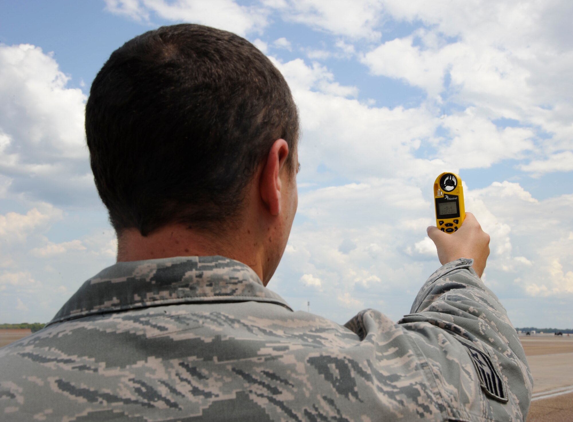 Tech. Sgt. Larry Woodson, 2nd Operations Support Squadron weather technician, uses a kestrel on the flightline at Barksdale Air Force Base, La., Aug. 22, 2013. The kestrel is used to read wind direction, dew point, wind pressure and temperature. The findings are used to brief aircrew. (U.S. Air Force photo/Airman 1st Class Andrew Moua)