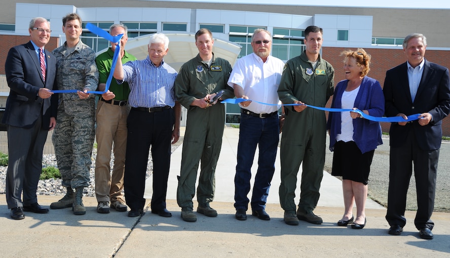 Col. Alex Mezynski, 5th Bomb Wing commander, joins congressional and civic leaders in a ribbon cutting ceremony to commemorate the grand opening of the Base Operations Building and Air Traffic Control Tower at Minot Air Force Base, N.D., Aug. 23, 2013. Base leadership came together with local leaders to speak of the great improvements these structures are for the base’s mission. (U.S. Air Force photo/Airman 1st Class Andrew Crawford)