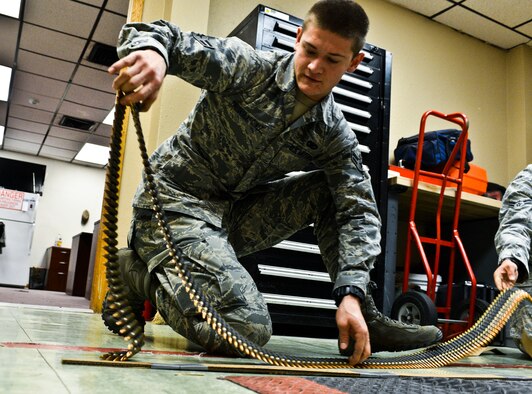 Airman 1st Class Julius Prefontaine-Gomez, 56th Security Forces Squadron patrolman, counts M-240B machine gun ammunition prior to firing the weapon. (U.S. Air Force photo/Senior Airman David Owsianka)