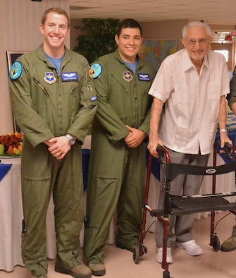 1st Lts. Brian Herring and Joshua Rosecrans, 309th Fighter Squadron student pilots, pose for a photo with Albert Winston, World War II pilot, Aug. 3 at his home in Peoria. The pilots visited and shared stories with Winston in celebration of his 90th birthday. (Courtesy photo)