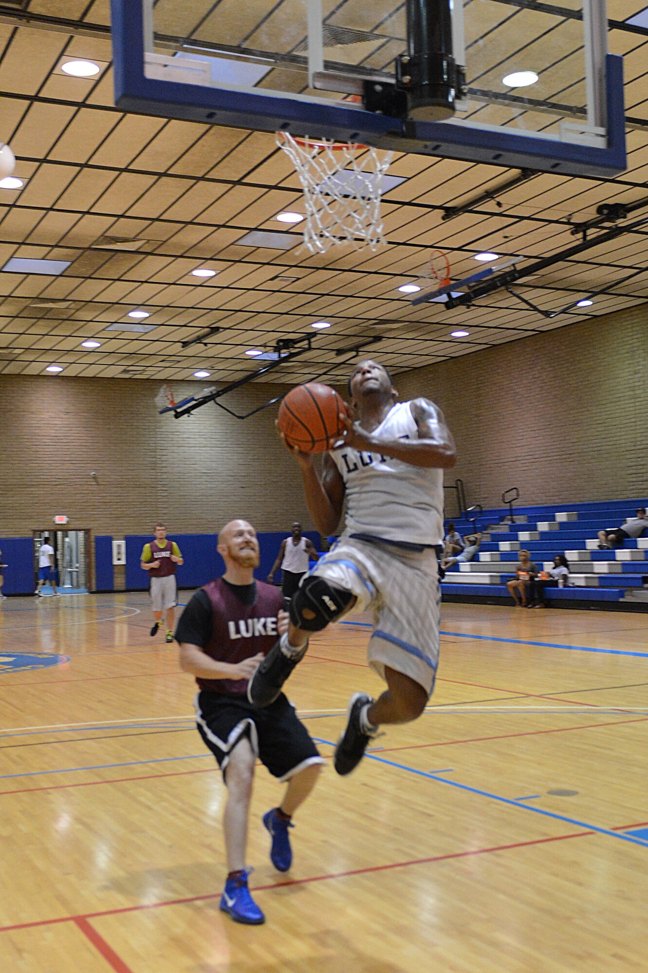 Guy McAdams, 56th Medical Group, performs a lay-up during an intramural basketball game against the 56th Force Support Squadron Aug. 15. McAdams scored 12 points in the game. (U.S. Air Force photo/Airman 1st Class Devante Williams)