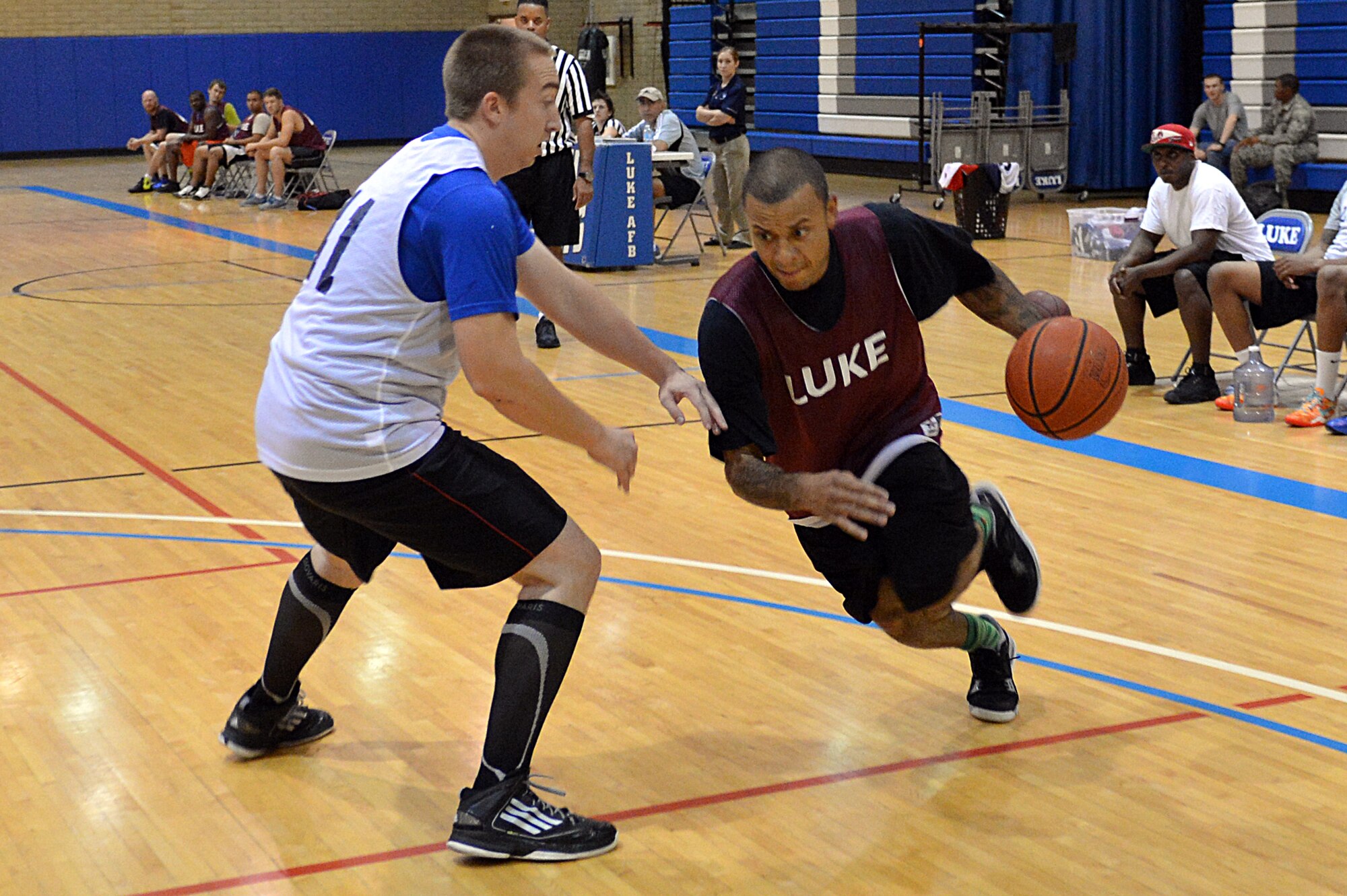 Jeremy Martinez, 56th Force Support Squadron, attempts to pass the defender during an intramural basketball game against 56th Medical Group at the Luke Air Force Base Bryant Fitness Center. MDG defeated FSS 42-39. (U.S. Air Force photo/Airman 1st Class Devante Williams)