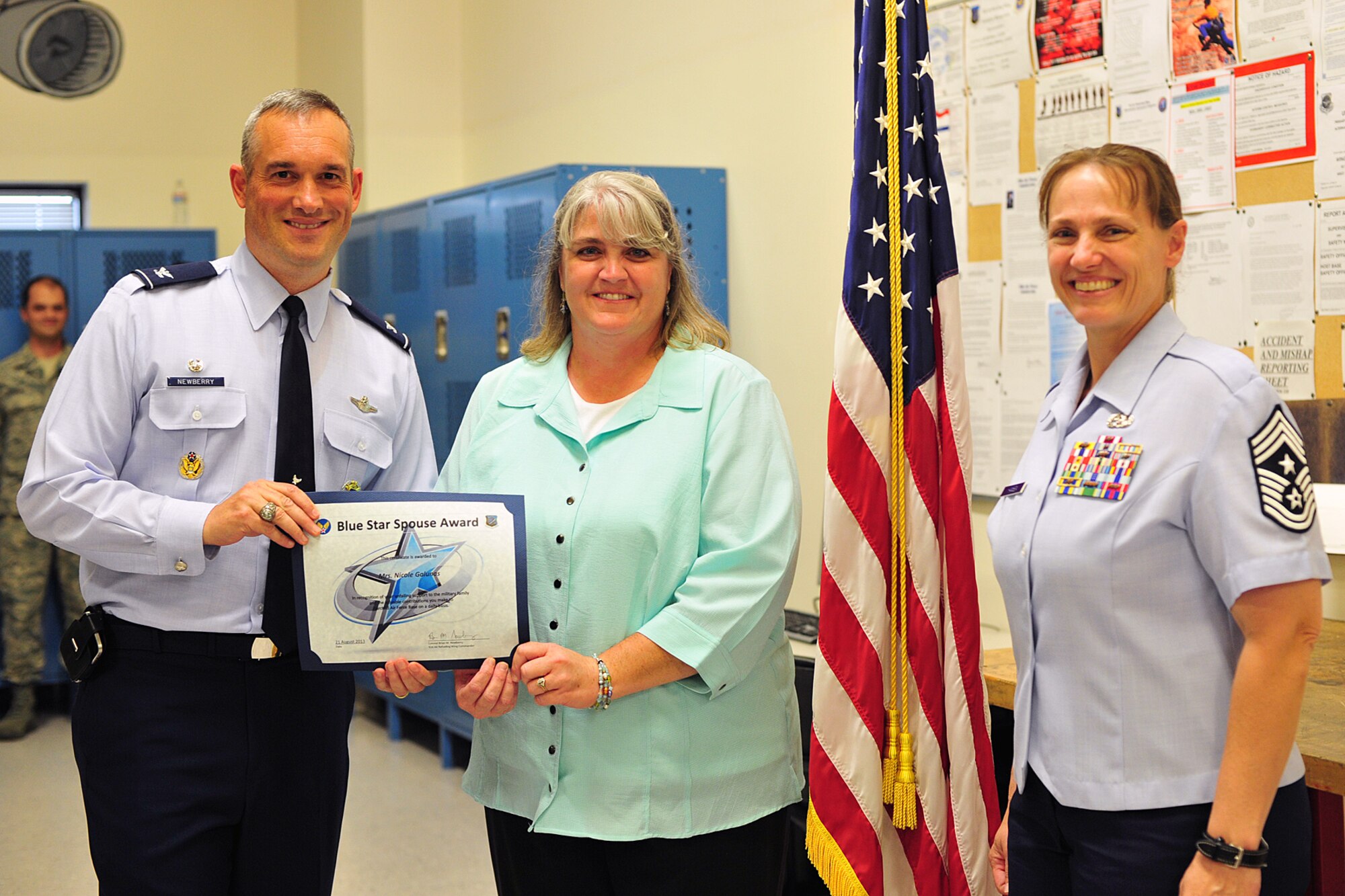 Col. Brian Newberry, 92nd Air Refueling Wing commander, and Chief Master Sgt. Wendy Hansen, 92nd Air Refueling Wing command chief, present the Blue Star Spouse Award
to Nicole Galunas at Fairchild Air Force Base, Wash., Aug. 21, 2013. Galunas has gone above and beyond as a key spouse for her squadron, 92nd Aircraft Maintenance Squadron, to support all the Airmen and their families. Blue Star Spouse award nominations for deserving spouses should be submitted to their chain of command. (U.S. Air Force photo by Senior Airman Taylor Curry/Released)